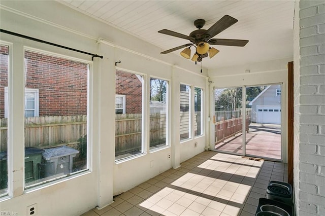 sunroom featuring ceiling fan