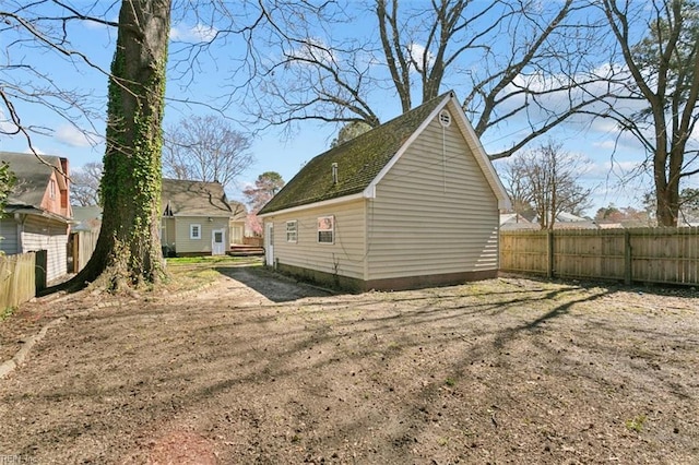 view of yard featuring an outdoor structure and fence