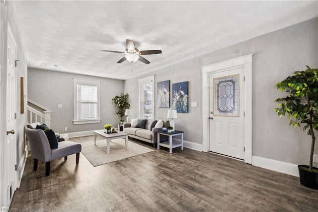 living room with a ceiling fan, stairway, wood finished floors, and baseboards