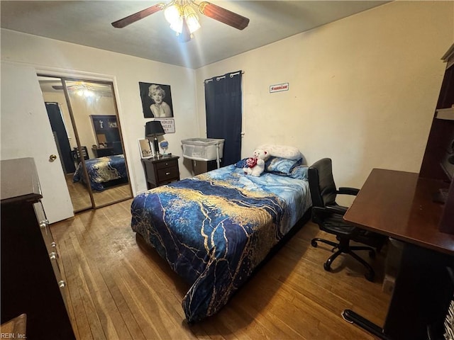 bedroom with hardwood / wood-style flooring and a ceiling fan