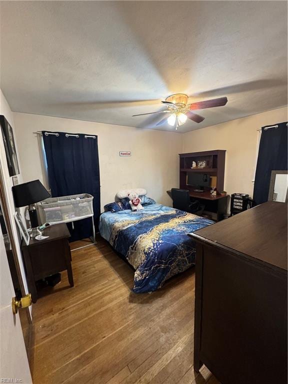 bedroom with wood finished floors and a ceiling fan