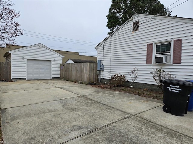 detached garage with fence and driveway