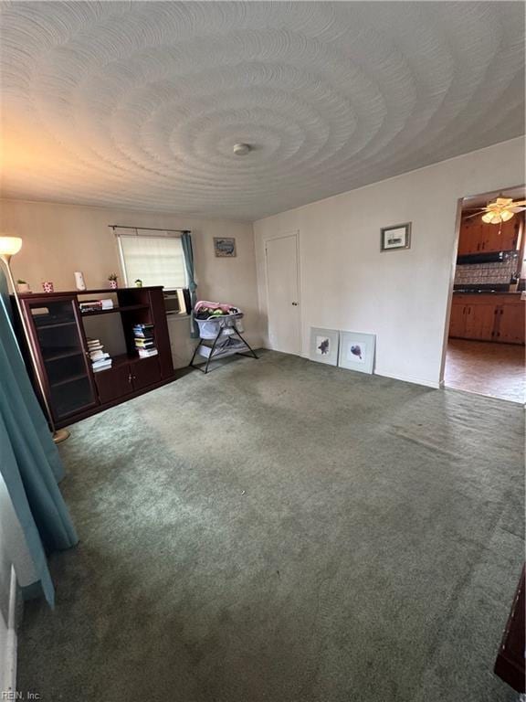 unfurnished living room with a textured ceiling and carpet floors