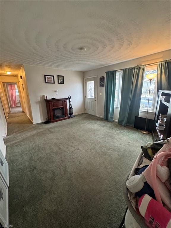 living room with a fireplace and carpet floors