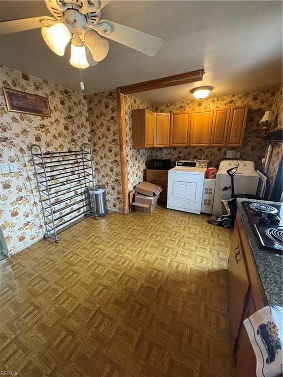 kitchen with brown cabinetry, wallpapered walls, washer / clothes dryer, and black microwave