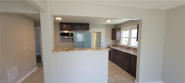 1832 Roanoke Ave, Newport News, VA 23607 - kitchen featuring light tile patterned floors, a sink, visible vents, dark brown cabinetry, and appliances with stainless steel finishes