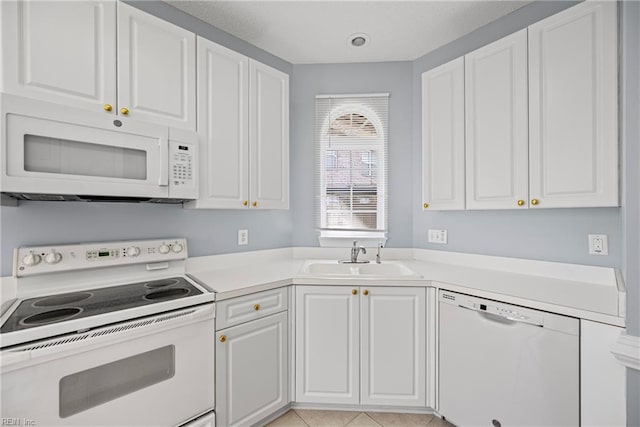 kitchen featuring white cabinetry, white appliances, light countertops, and a sink
