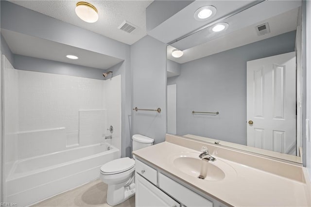 bathroom with visible vents, toilet, vanity, and a textured ceiling