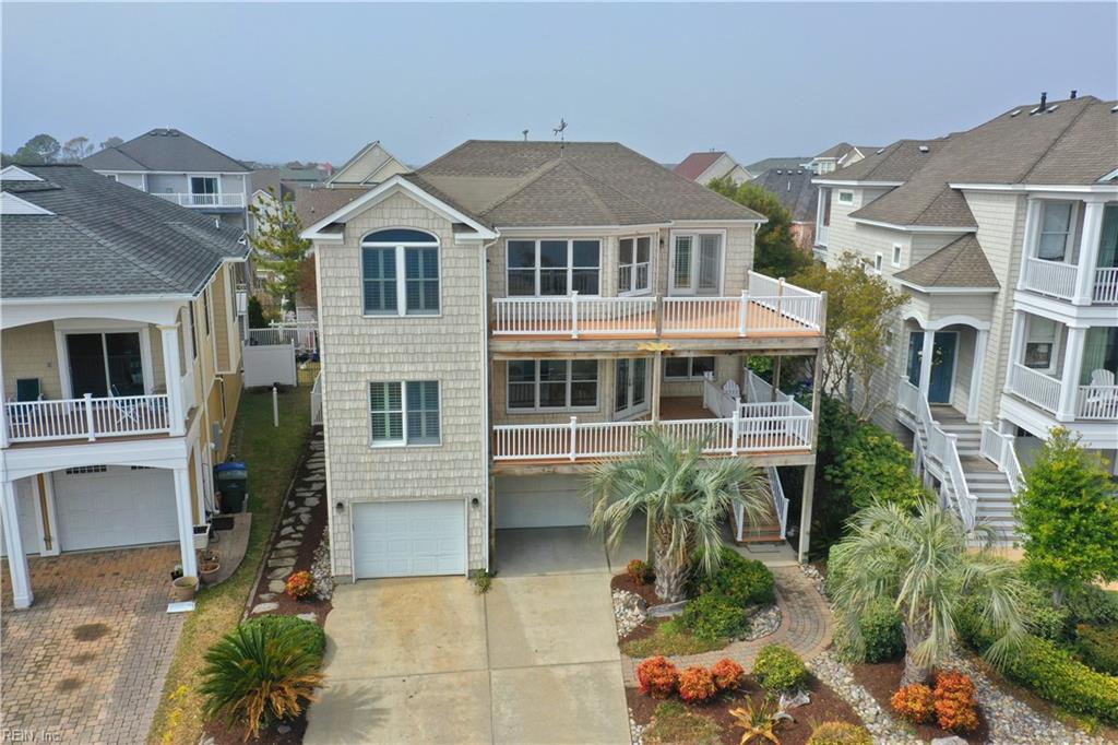 exterior space featuring stairs, a residential view, concrete driveway, and an attached garage