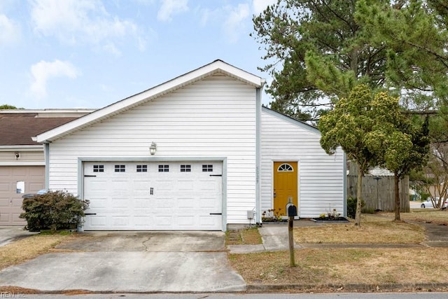 exterior space featuring concrete driveway and fence