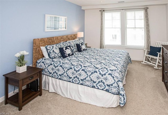 bedroom with light carpet and baseboards