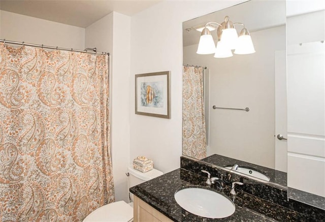 bathroom featuring toilet and vanity