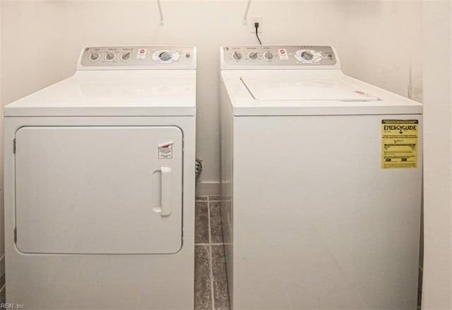 clothes washing area featuring laundry area and washer and clothes dryer