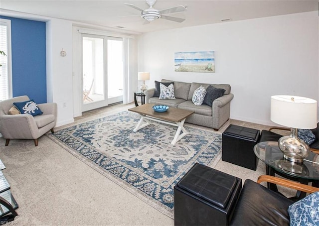 living room featuring visible vents, plenty of natural light, and a ceiling fan