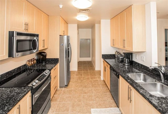 kitchen with visible vents, light brown cabinetry, a sink, appliances with stainless steel finishes, and light tile patterned flooring