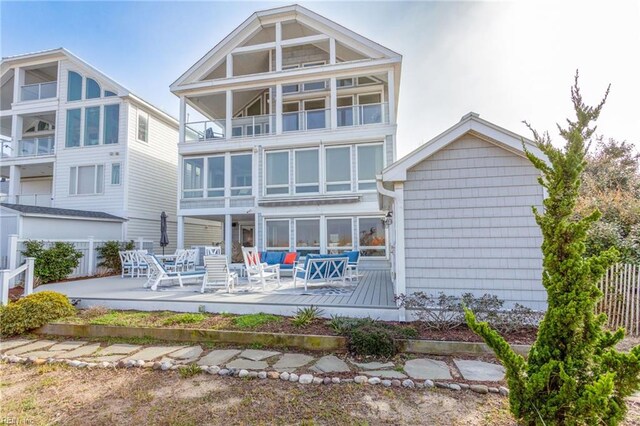 back of property featuring a patio, a balcony, and fence