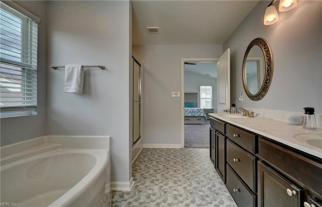 ensuite bathroom featuring a shower stall, a sink, connected bathroom, a garden tub, and visible vents