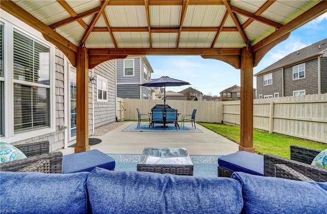 view of patio with a fenced backyard, an outdoor hangout area, and a gazebo