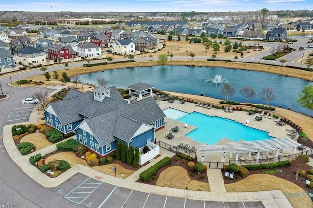 bird's eye view featuring a residential view and a water view
