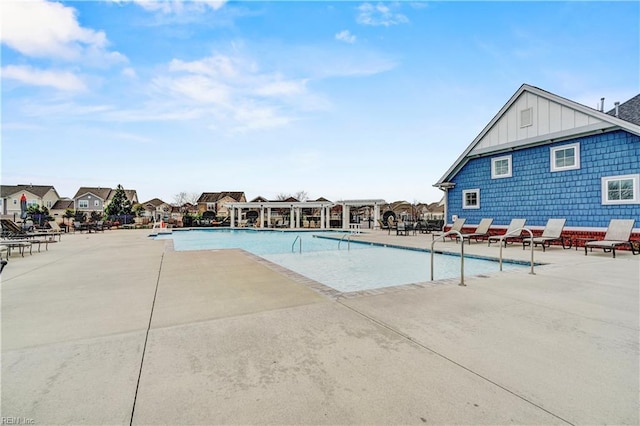 pool with a pergola, a residential view, and a patio