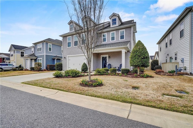 view of front facade featuring a residential view, driveway, and an attached garage