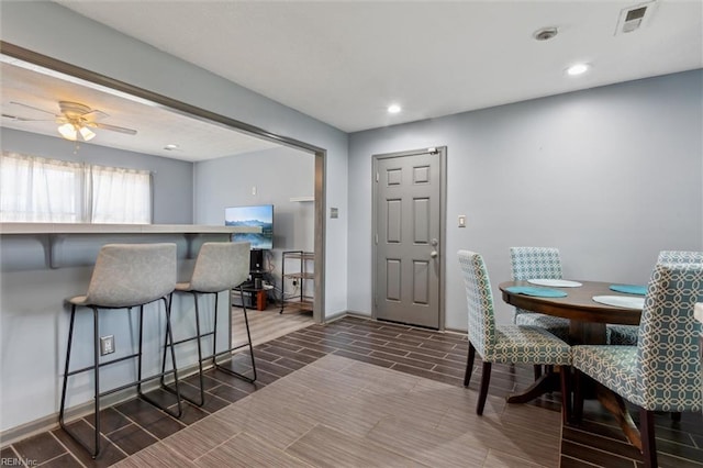 dining area with wood tiled floor, baseboards, recessed lighting, and visible vents
