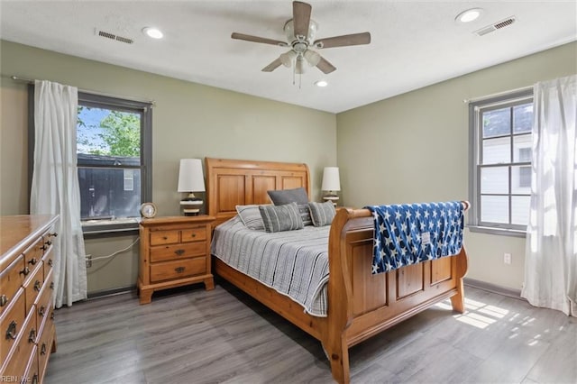 bedroom featuring light wood-style floors, ceiling fan, recessed lighting, and visible vents