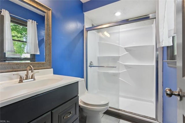 full bath with vanity, tile patterned floors, a stall shower, and toilet