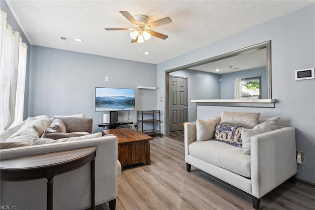 living room featuring recessed lighting, ceiling fan, and wood finished floors