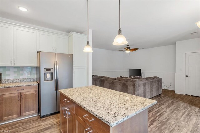7922 Shore Dr Unit 304, Norfolk, VA 23518 - kitchen featuring wood finished floors, ceiling fan, stainless steel fridge, white cabinetry, and tasteful backsplash