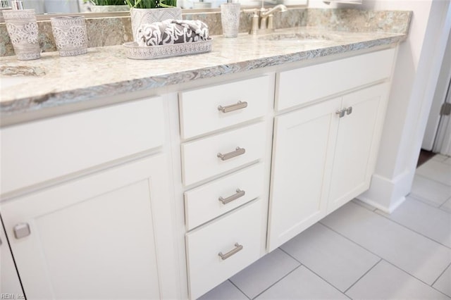 bathroom with tile patterned floors and vanity