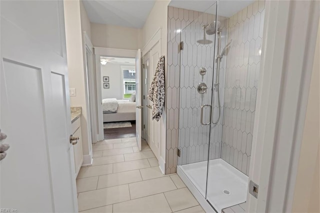 bathroom featuring tile patterned floors, vanity, a stall shower, and ensuite bathroom
