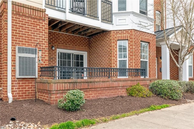 view of exterior entry with brick siding