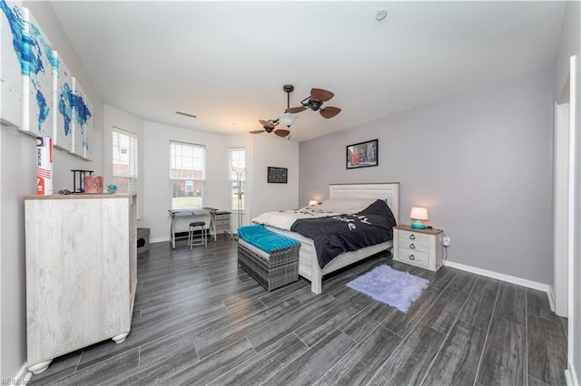 bedroom featuring visible vents, baseboards, dark wood-style floors, and a ceiling fan