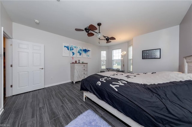 bedroom featuring a ceiling fan, dark wood-type flooring, and baseboards