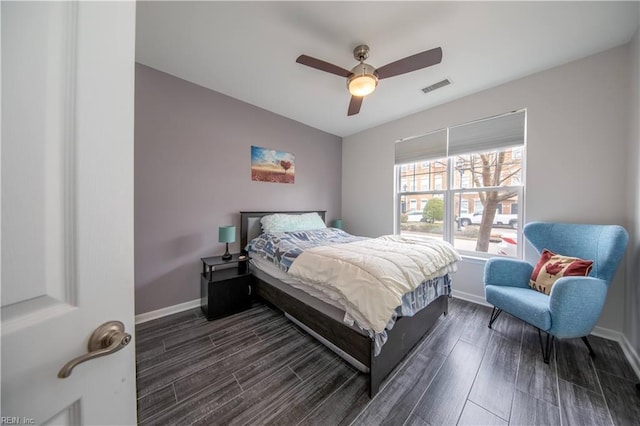 bedroom with a ceiling fan, baseboards, visible vents, and wood finish floors