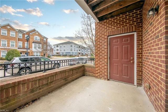 exterior space featuring brick siding and a residential view