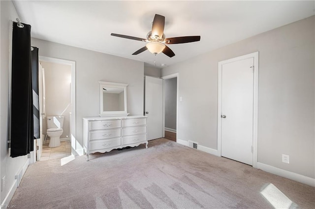 unfurnished bedroom featuring visible vents, light colored carpet, ensuite bath, and baseboards