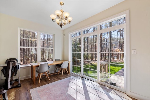 office area featuring an inviting chandelier, baseboards, and wood finished floors
