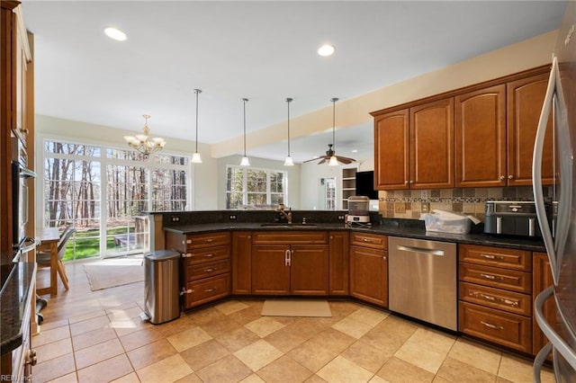 kitchen with a sink, plenty of natural light, backsplash, and appliances with stainless steel finishes
