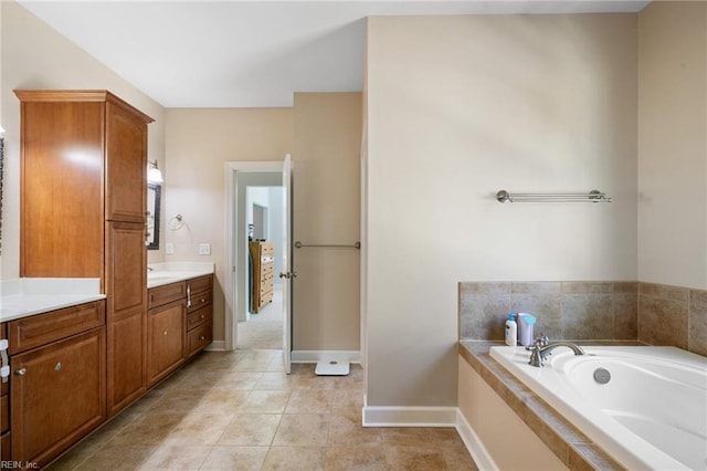 full bathroom with tile patterned floors, vanity, baseboards, and a garden tub