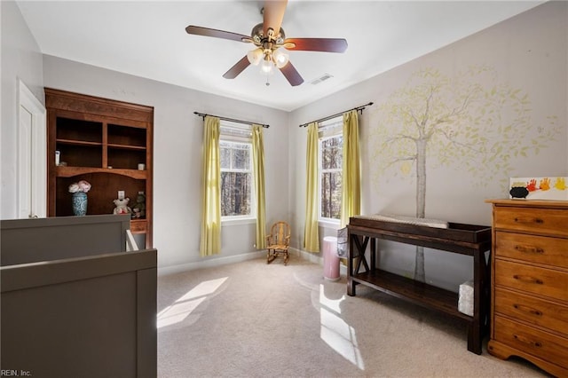 carpeted bedroom featuring baseboards, visible vents, and ceiling fan