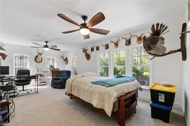 carpeted bedroom with baseboards and ceiling fan