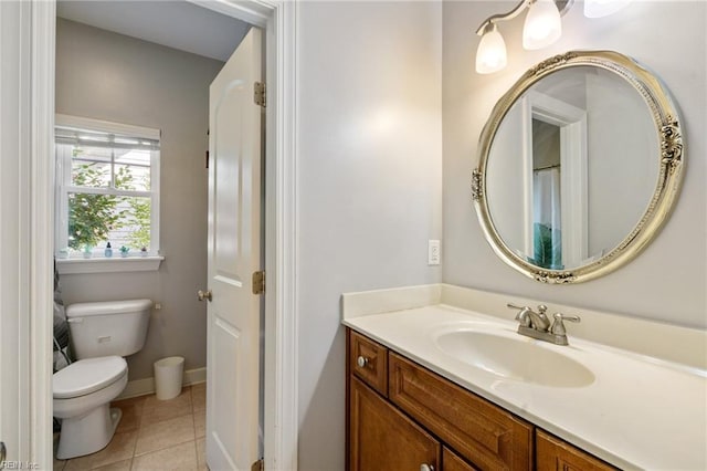 bathroom featuring baseboards, toilet, tile patterned floors, and vanity