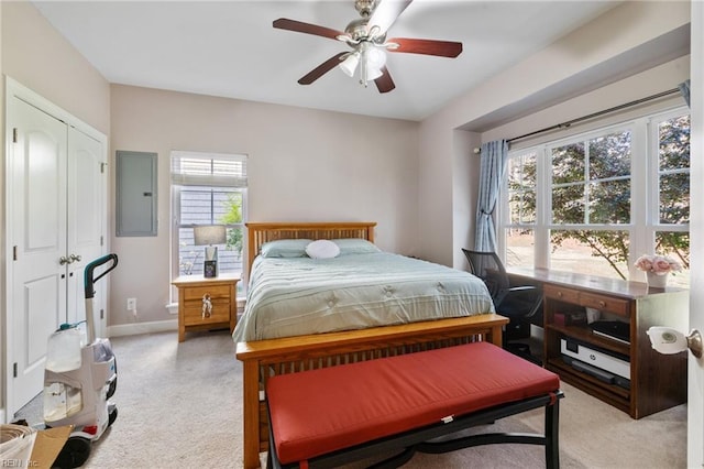bedroom with baseboards, ceiling fan, and electric panel