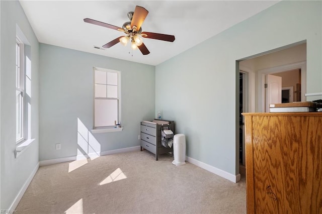 carpeted bedroom with baseboards, visible vents, and multiple windows