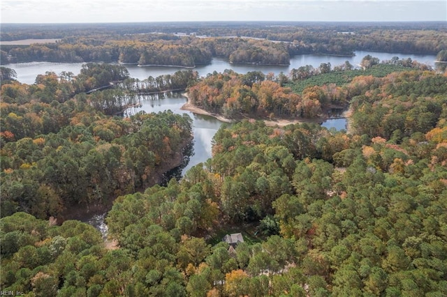 birds eye view of property with a wooded view and a water view