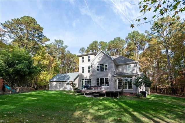 back of house with a lawn, fence, a wooden deck, and a playground