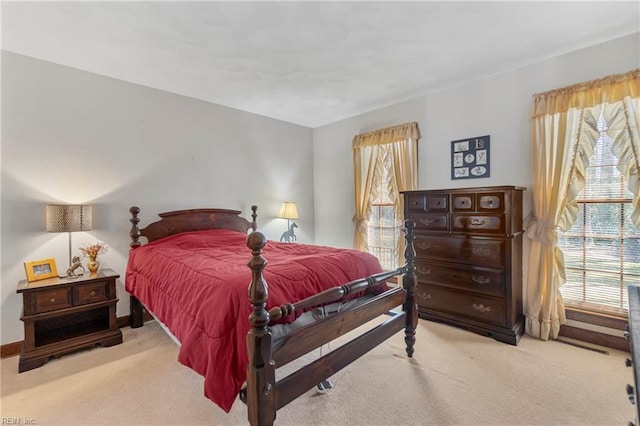 bedroom with multiple windows and carpet floors