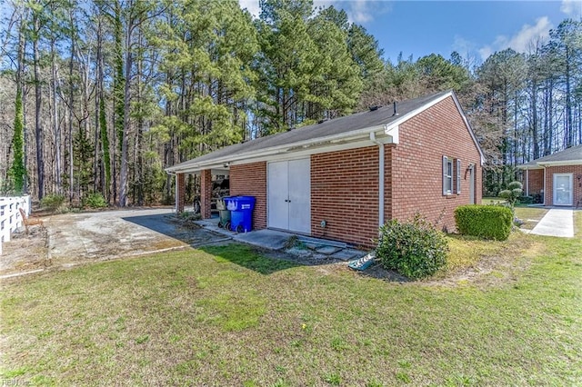 view of property exterior featuring a lawn and brick siding